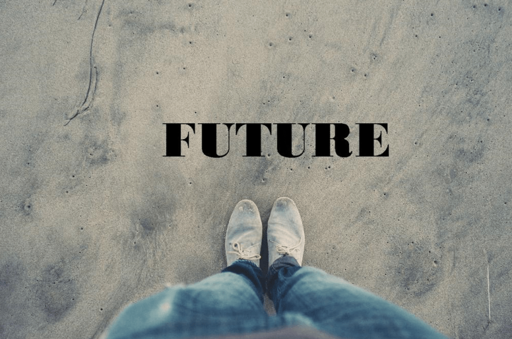 Photo of a person's legs and feet standing looking forward on a beach with the text 'FUTURE' above.